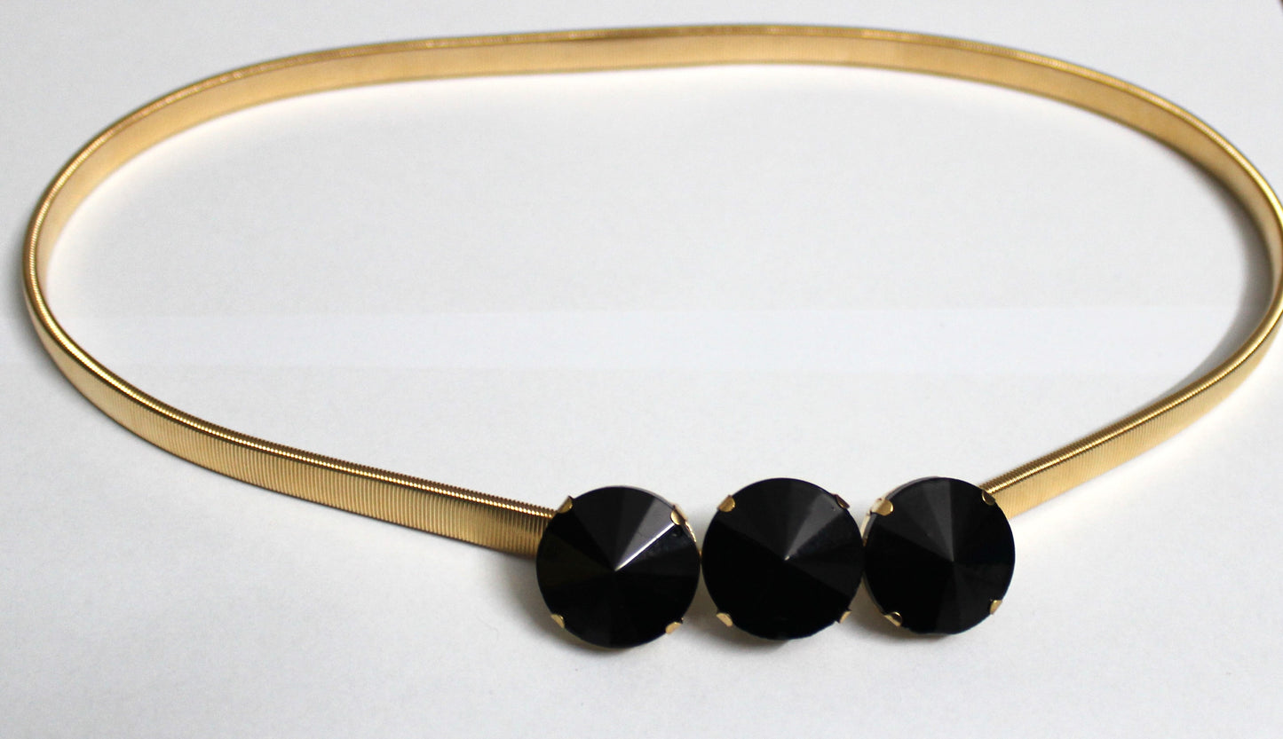 Golden belt with black stones