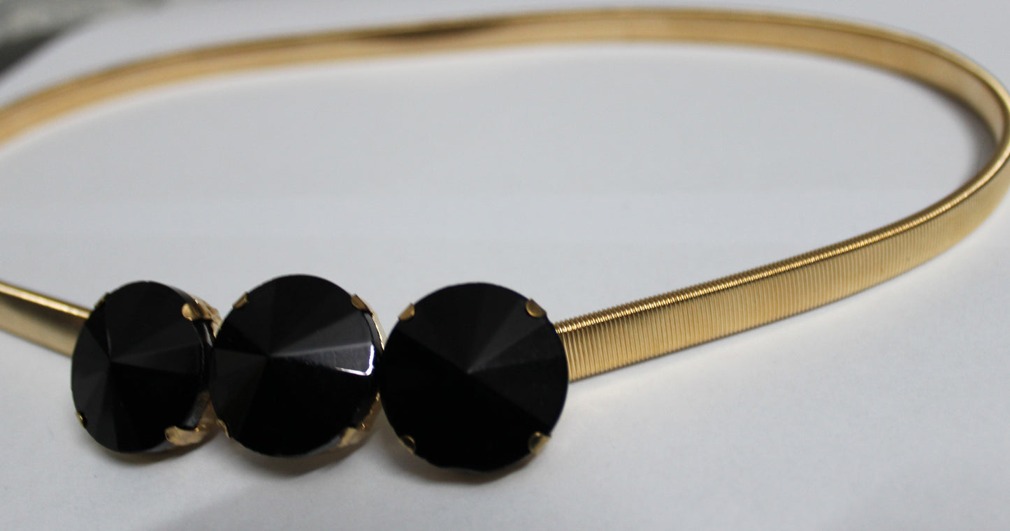 Golden belt with black stones